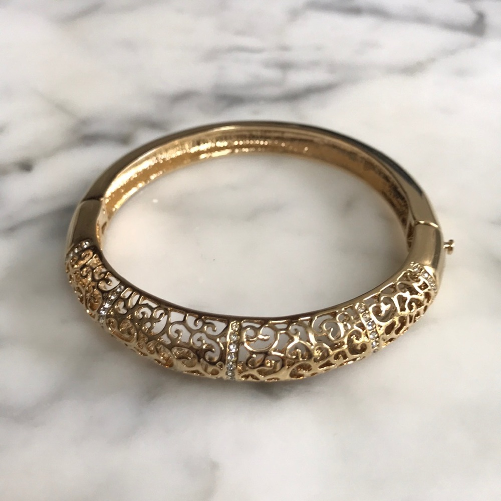 Gold tone bracelet with decorative stones